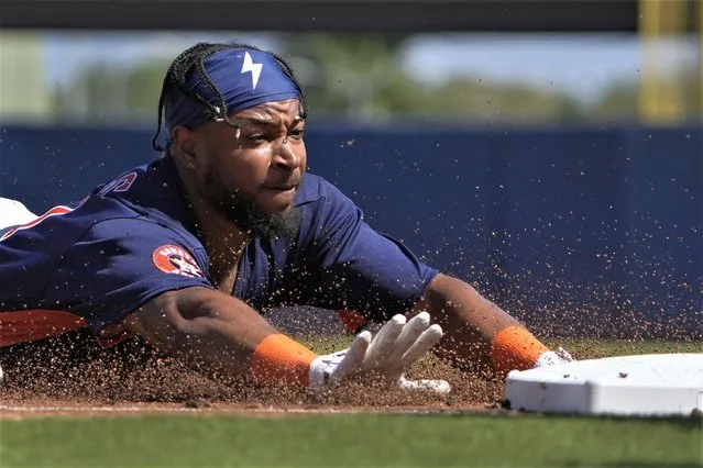 Houston Astros' Corey Julks reaches for third as he dives in for a triple during the second inning of a spring training baseball game against the Miami Marlins in West Palm Beach, Fla., Monday, February 27, 2023. (Photo by Jeff Roberson/AP Photo)