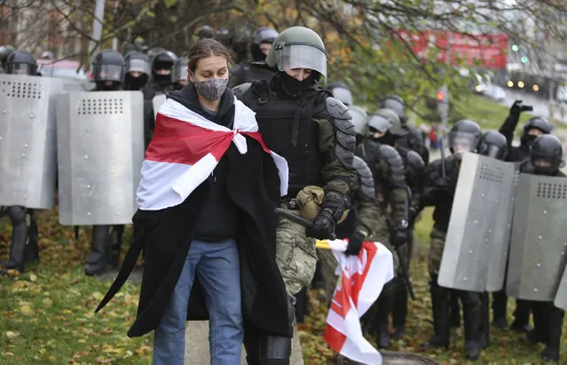 Police detain a protestor during an opposition rally to protest the official presidential election results in Minsk, Belarus, Sunday, November 8, 2020. Club-swinging police went after demonstrators in the Belarusian capital who were demanding the resignation of the country's authoritarian president on Sunday, the 90th consecutive day of protests in the country. Human rights activists said nearly 400 people were arrested. (Photo by AP Photo/Stringer)