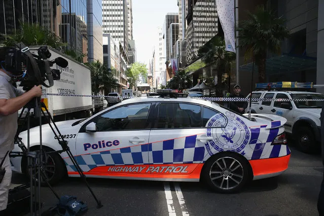 Police secure the scene near Lindt Cafe, Martin Place on December 15, 2014 in Sydney, Australia. Major landmarks in Sydney, including the Sydeny Opera House, have been evacuated as police respond to a hostage situation inside a Martin Place cafe. (Photo by Don Arnold/Getty Images)