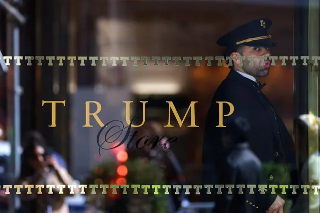 A doorman stands inside the Trump Tower in Manhattan, New York City, U.S., March 18, 2023. (Photo by Andrew Kelly/Reuters)