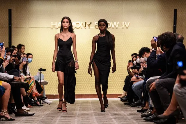 This picture taken on November 6, 2020 shows Harmony Anne-Marie Ilunga (R), 22, who moved to Hong Kong as a child refugee from the Democratic Republic of Congo, and another model presenting creations during the “Harmony IV” fashion show in Hong Kong, which aims to celebrate the city's diversity. As a young black woman modelling in Hong Kong, Harmony Anne-Marie Ilunga rarely saw anyone who looked like her in the magazines. Now the 22-year-old is trying to change that – one model at a time. (Photo by Anthony Wallace/AFP Photo)