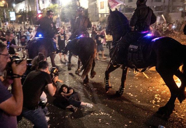 Israeli police intervene with demonstrators as thousands of Israelis gather with Israeli flags and banners to demonstrate demanding a ceasefire on Gaza, the return of Israeli prisoners to their homes and early elections in Tel Aviv, Israel on June 01, 2024. The demonstration in Tel Aviv is expected to expand, with additional protests anticipated in other cities and areas across Israel. (Photo by Mostafa Alkharouf/Anadolu via Getty Images)