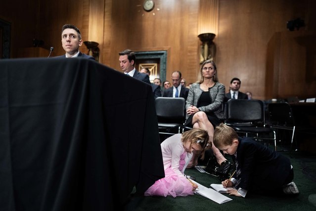 The children of Travis Hill, President Donald Trump’s nominee to be chairman of the Federal Deposit Insurance Corporation, draw on notepads during his confirmation hearing in Washington, DC, on Thursday, October 30, 2025. (Photo by Tom Williams/CQ-Roll Call, Inc/Getty Images)