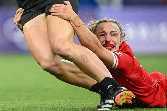 Canada's Krissy Scurfield tackles New Zealand's Jazmin Felix-Hotham during a rugby sevens match at the Olympics on Sunday, July 28, 2024. The two teams would eventually play for the gold medal. New Zealand won 19-12. (Photo by Carl de Souza/AFP Photo)