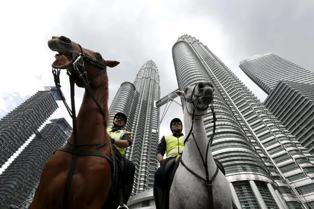 Malaysian police patrol on horses in front of the Petronas towers at the venue of the 27th ASEAN summit in Kuala Lumpur, Malaysia, November 21, 2015. (Photo by Jorge Silva/Reuters)