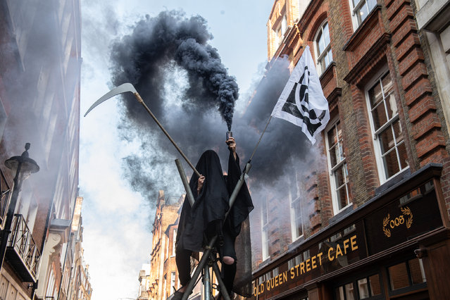 Supporters of Extinction Rebellion occupy the street outside the offices of the Policy Exchange think tank in protest at their ties to the fossil fuel industry at Westminster on July 29, 2024 in London, England. (Photo by Guy Smallman/Getty Images)