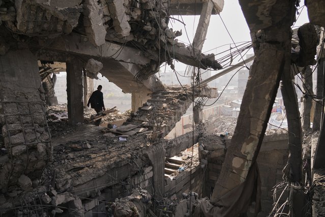 A Palestinian walks through the ruins of a building damaged by an Israeli strike the day before, in Gaza City, November 20, 2025. (Photo by Jehad Alshrafi/AP Photo)