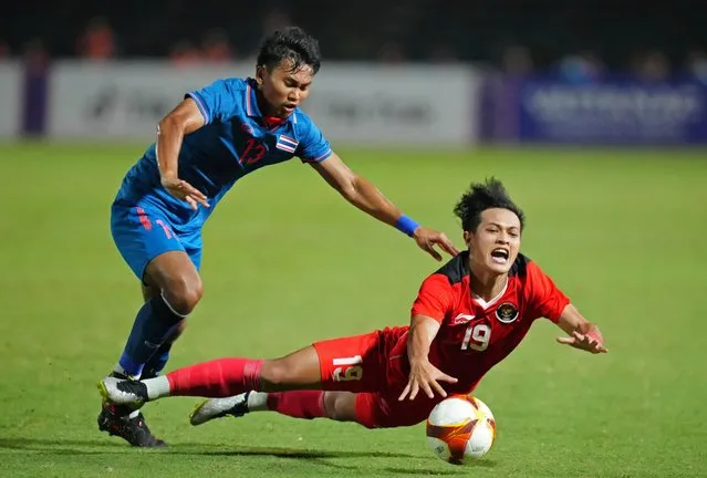 Indonesia's Alfeandra Dewangga Santosa in action with Thailand's Phongsakon Trisat during the men's football final against Thailand at Olympic National Stadium in Phnom Penh, Cambodia on May 16, 2023. (Photo by Cindy Liu/Reuters)