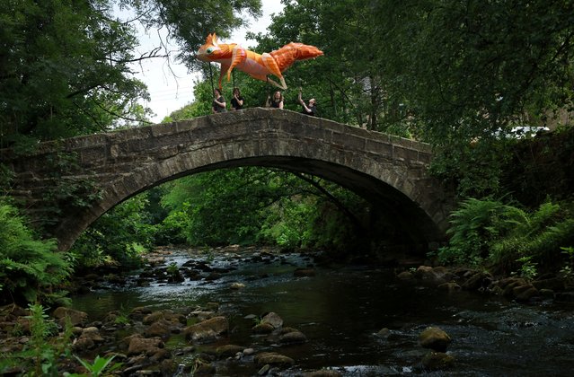 Artists from Handmade Productions carry a puppet of a red squirrel over a bridge ahead of this weekend's Handmade Parade in Hebden Bridge, Britain on June 20, 2025. (Photo by Phil Noble/Reuters)