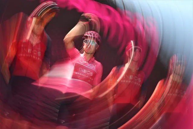 A photo taken with a long exposure and a movement effect shows overall leader INEOS Grenadiers's British rider Geraint Thomas waves onstage during the presentation of the teams prior to the nineteenth stage of the Giro d'Italia 2023 cycling race, 183 km between Longarone and Tre Cime di Lavaredo, on May 26, 2023. (Photo by Luca Bettini/AFP Photo)
