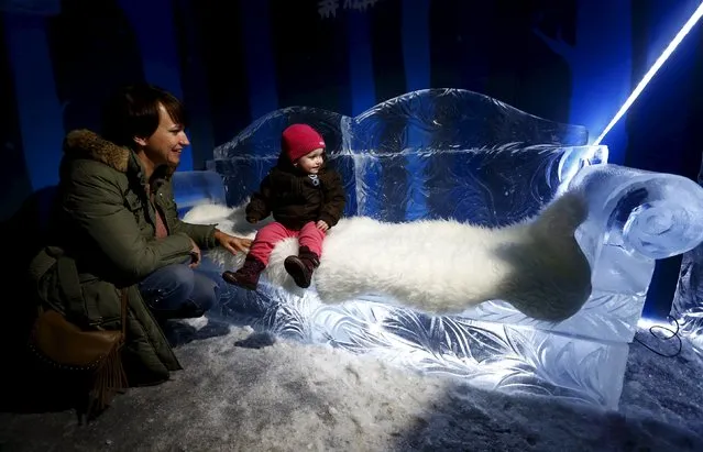 A woman with a child visit an ice room with ice sculptures at a mall in Minsk, Belarus, December 7, 2015. (Photo by Vasily Fedosenko/Reuters)