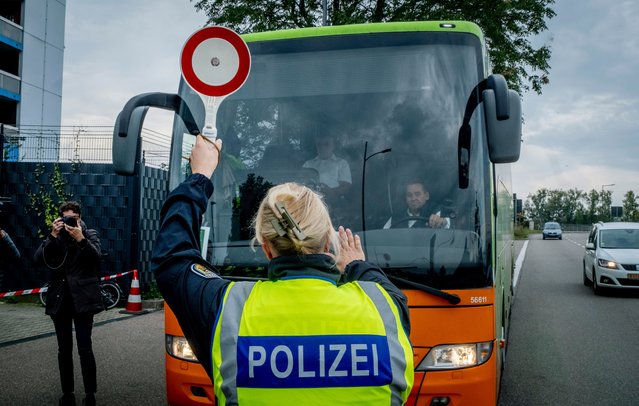 A German police officer stops a bus at the border between Germany and France in Kehl, Germany, Monday, September 16, 2024, as Germany begins carrying out checks at all its land borders. (Photo by Michael Probst/AP Photo)