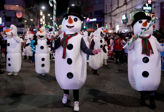 People dressed as snowmen dance during the annual Christmas Parade in La Paz, Bolivia, Monday, December 2, 2024. (Photo by Juan Karita/AP Photo)