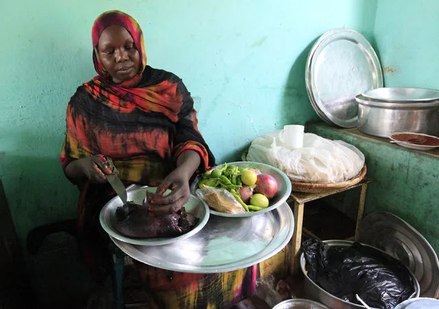 A woman prepares a dish of camel liver at her shop in Tamboal village market in Al Jazeera April 16, 2011. According to the Sudanese Ministry of Animals Resources in 2003, the country produced about 72,000 to 81,000 tonnes of camel meat annually from 1996 to 2002. (Photo by Mohamed Nureldin Abdallah/Reuters)