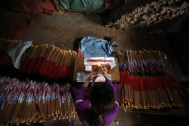A labourer packs incense in preparation for Tet, the traditional Vietnamese lunar new year, in Hong Chau village, outside Hanoi January 29, 2015. Tet is from February 14 till 24. (Photo by Reuters/Kham)