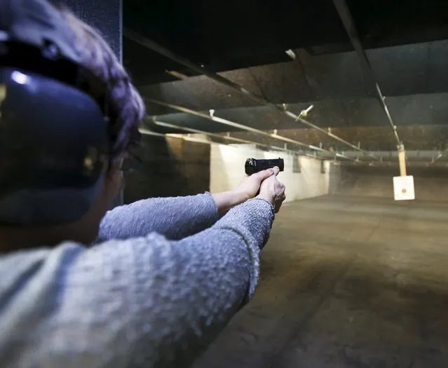 First time gun owner, Jessie Palmieri fires a H&K VP9 9mm at the Ringmasters of Utah gun range, in Springville, Utah on December 18, 2015. (Photo by George Frey/Reuters)