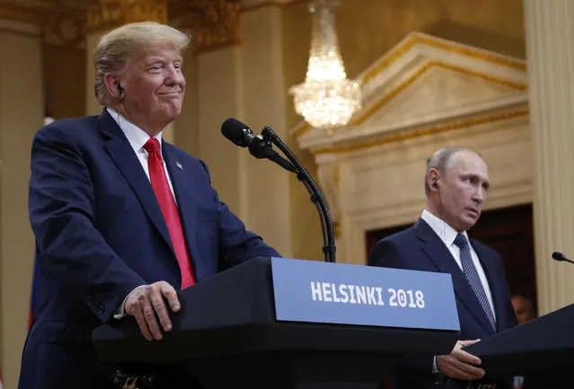 U.S. President Donald Trump, left, smiles beside Russian President Vladimir Putin during a press conference after their meeting at the Presidential Palace in Helsinki, Finland, Monday, July 16, 2018. (Photo by Pablo Martinez Monsivais/AP Photo)