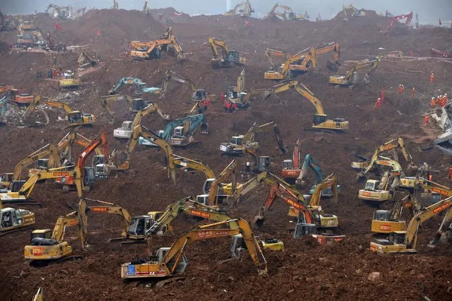 Excavators are seen during rescue operations at an industrial estate hit by a landslide in Shenzhen, Guangdong province, December 23, 2015. (Photo by Kim Kyung-Hoon/Reuters)