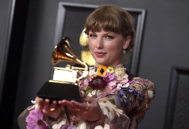 Taylor Swift poses in the press room with the award for album of the year for “Folklore” at the 63rd annual Grammy Awards at the Los Angeles Convention Center on Sunday, March 14, 2021. (Photo by Jordan Strauss/Invision/AP Photo)