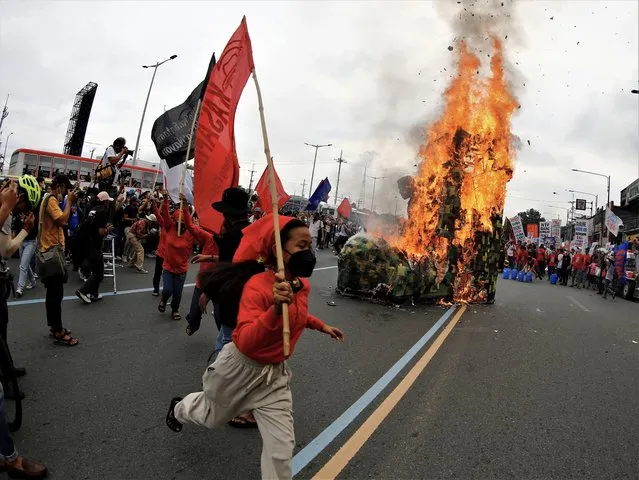 Activists burn an effigy during a protest rally along a road leading to the Congress compound in Quezon city, Metro Manila, Philippines, 24 July 2023. The protesters gathered against the State of the Nation Address (SONA) of President Ferdinand “Bongbong” Marcos. (Photo by Francis R. Malasig/EPA)
