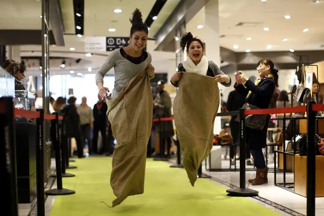 People participate in a sack race at a shopping center in Paris on the first day of the winter sales in France, January 6, 2016. (Photo by Benoit Tessier/Reuters)