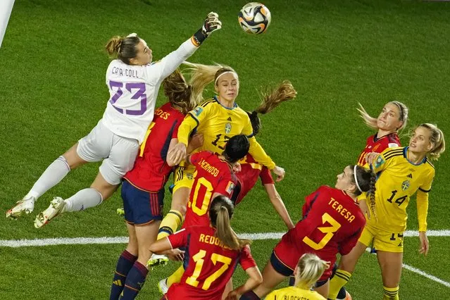 Spain's goalkeeper Cata Coll, left, punches the ball away to make a save during the Women's World Cup semifinal soccer match between Sweden and Spain at Eden Park in Auckland, New Zealand, Tuesday, August 15, 2023. (Photo by Abbie Parr/AP Photo)