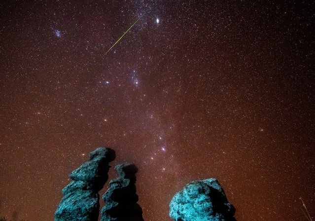 A long exposure photo shows Leonids meteor shower in the night sky over the Stone Dolls in Kuklice, near Kratovo, Republic of No​rth Macedonia, 17 November 2020. (Photo by Georgi Licovski/EPA/EFE)