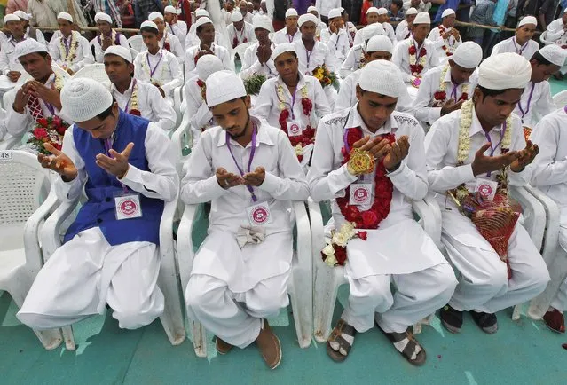Muslim grooms pray after taking their wedding vows, at a mass marriage ceremony in the western Indian city of Ahmedabad, February 15, 2015. (Photo by Amit Dave/Reuters)