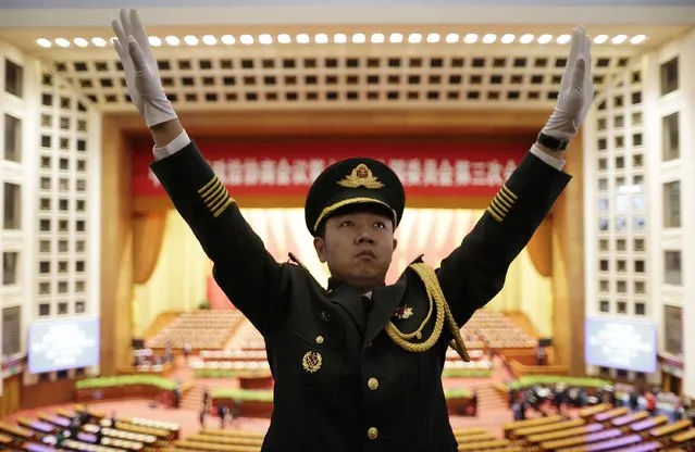 A military band conductor practices during rehearsal ahead of the opening session of Chinese People's Political Consultative Conference (CPPCC) at the Great Hall of the People in Beijing, March 3, 2015. REUTERS/Jason Lee