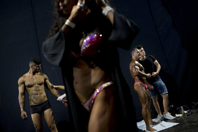 In this Thursday, October 18, 2018 photo, contestants get ready backstage during the National Amateur Body Builders' Association competition in Tel Aviv, Israel. (Photo by Oded Balilty/AP Photo)