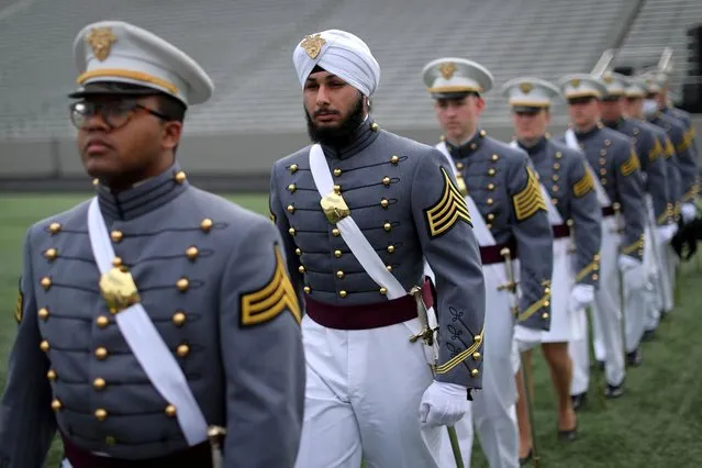 Graduating senior Gurjiwan Singh Chahal, a member of the Sikh faith, wears a turban as he marches into Michie Stadium with his fellow senior classmates for graduation ceremonies for the class of 2021 at the United States Military Academy (USMA) West Point, in West Point, New York, May 22, 2021. (Photo by Mike Segar/Reuters)