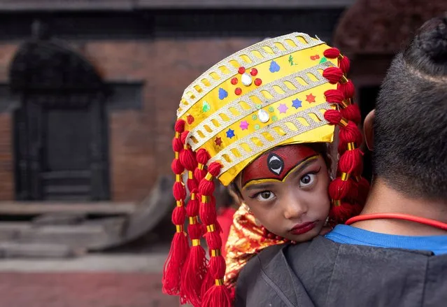 A Nepalese girl in traditional attire takes part in Kumari Puja, a mass worship ceremony for preteen girls, in Kathmandu, Nepal on September 27, 2023. In Nepal, Kumari Puja is the tradition of selecting a Kumari, usually a preadolescent girl, to worship symbolically as a goddess. More than hundred girls under the age of nine from across the country gathered for the mass worship. Performing Kumari Puja for three continuous years is believed to protect the girls from diseases throughout their entire life. (Photo by Narendra Shrestha/EPA/EFE)