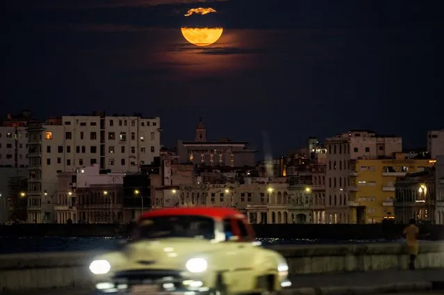 The “Blue Supermoon”, the second full moon of a calendar month, rises over Havana on August 30, 2023. (Photo by Yamil Lage/AFP Photo)
