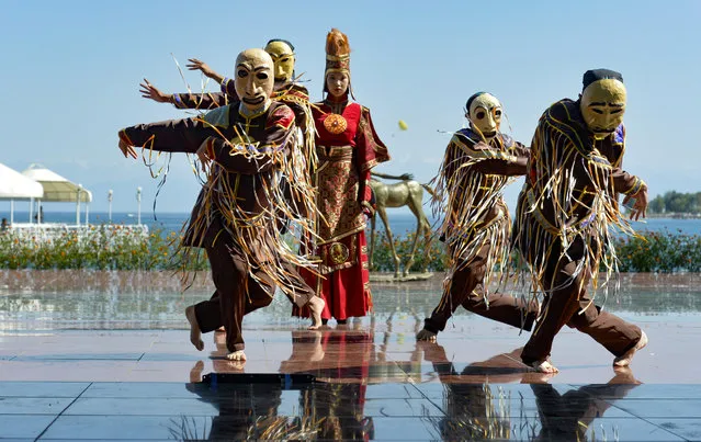 Members of the Russian Folk Dance Ensemble of Adygea perform during the World Nomads Fashion festival Issyk-Kul 2022, at Cholpon-Ata, a resort town on the northern shore of Lake Issyk-Kul, 207 kilometers (129 miles) east of Bishkek, Kyrgyzstan, Friday, July 22, 2022. On the shore of one of the world's largest lakes, high up in Kyrgyzstan's Tian Shan mountains, models strutted and sashayed in outfits mixing the ancient and modern at the World Nomads Fashion festival. (Photo by Vladimir Voronin/AP Photo)