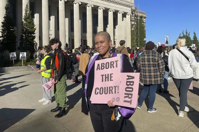 Alessia Huaman holds pink signs, Monday, October 16, 2023, outside the Cyrus Northrop Memorial Auditorium in Minneapolis, where U.S. Supreme Court Justice Amy Coney Barrett was speaking. (Photo by Trisha Ahmed/AP Photo)