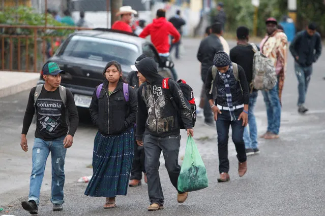 Migrants from Central America and other countries walk before arriving at the border checkpoint in Agua Caliente on the border between Honduras and Guatemala, in Ocotepeque municipality, Honduras, December 22, 2016. (Photo by Jorge Cabrera/Reuters)