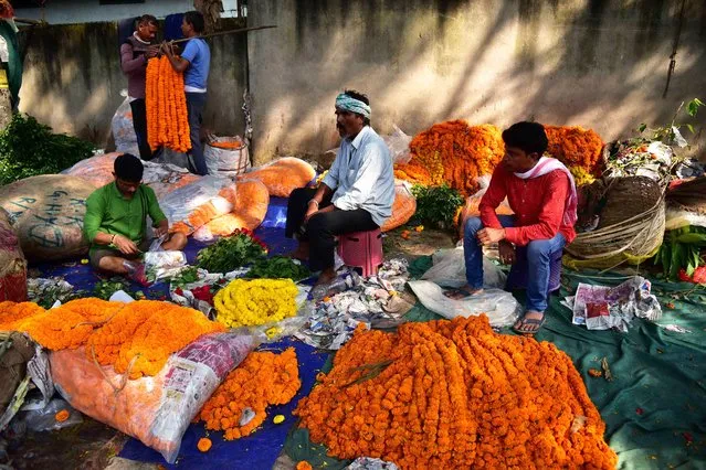 Vendors sell flowers ahead of the Diwali festival, in Guwahati, India on November 12, 2023. (Photo by Anuwar Hazarika/NurPhoto/Rex Features/Shutterstock)