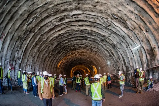Engineers workers and media person inspect the under construction Zojila tunnel which will connect Kashmir with Ladakh union territories, on September 28, 2021 in Baltal 100 km east of Srinagar, Indian administered Kashmir, India. Zojila serves as the only road Link between Kashmir and Ladakh which holds strategic significance as Zojila Pass is situated at an altitude of 11,578 feet on the Srinagar-Kargil-Leh National highway and remains closed during winters due to heavy snowfall, cutting off Ladakh region from Kashmir. When completed, it will be the longest bidirectional tunnel in Asia. The 14 km long tunnel will reduce the time to cross the ZojiLa from more than 3 hours to just 15 minutes. (Photo by Yawar Nazir/Getty Images)