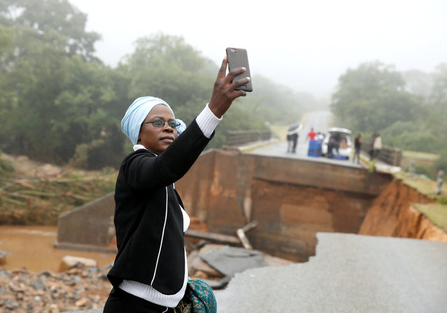 A woman takes a selfie at a washed away bridge along Umvumvu river following Cyclone Idai in Chimanimani, Zimbabwe, March 18, 2019. More than a thousand people are feared to have died in Mozambique alone while scores have been killed and more than 200 are missing in neighbouring Zimbabwe following the deadliest cyclone to hit southern Africa. Cyclone Idai tore into the centre of Mozambique on March 14 night before barreling on to neighbouring Zimbabwe, bringing flash floods and ferocious winds, and washing away roads and houses. (Photo by Philimon Bulawayo/Reuters)