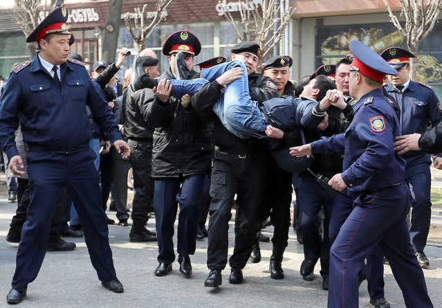 Police officers detain an anti-government protester during a rally in Almaty, Kazakhstan March 22, 2019. The parliament in this Central Asian nation voted earlier this week to change the name of the capital Astana to Nursultan after the outgoing long-time president. The new president will have to sign the decree to make the change official. (Photo by Pavel Mikheyev/Reuters)