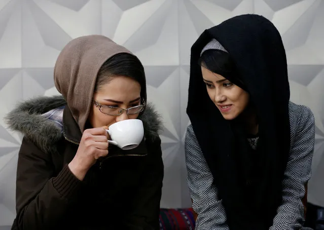 Sima Azimi (L), 20, a trainer and Sabera Bayanne, 20, a student at the Shaolin Wushu club, sit inside a restaurant in Kabul, Afghanistan February 2, 2017. (Photo by Mohammad Ismail/Reuters)