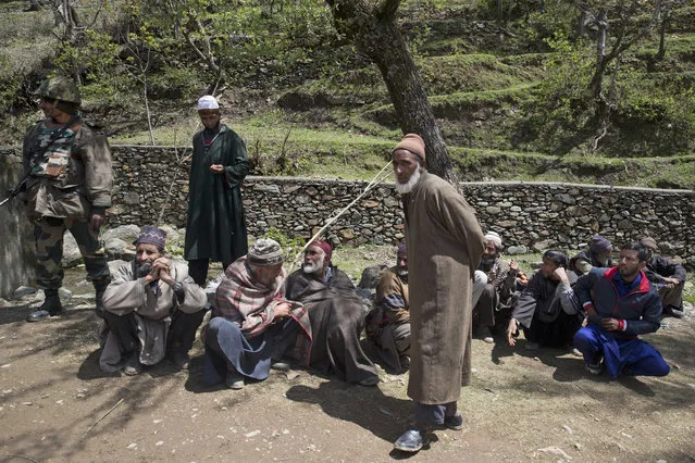 Elderly Kashmiri voters wait to cast their votes, outside a polling station during the second phase of India's general elections in Baba Nagri, about 44 kilometers (28 miles) northeast of Srinagar, Indian controlled Kashmir, Thursday, April 18, 2019. Kashmiri separatist leaders who challenge India's sovereignty over the disputed region have called for a boycott of the vote. Most polling stations in Srinagar and Budgam areas of Kashmir looked deserted in the morning with more armed police, paramilitary soldiers and election staff present than voters. (Photo by Dar Yasin/AP Photo)