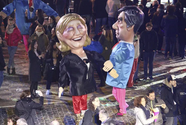 Big heads of French presidential candidates, Marine Le Pen, left, of the far-right National Front, and Francois Fillon of the right-wing Republicans party, join the Nice Carnival parade, Saturday, February 11, 2017, in Nice, southeastern France. Floats in the Carnival's 133rd edition that kicked off on Saturday were led by the King of Energy, this year's theme, and followed notably by a huge Donald Trump with hair dryers trained on his crown of blond hair. (Photo by Henri Grivot/AP Photo)