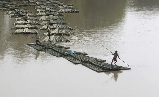 Bamboo logs are transported down the river Howrah near Chakmaghat village in the northeastern state of Tripura, India, March 31, 2016. (Photo by Jayanta Dey/Reuters)