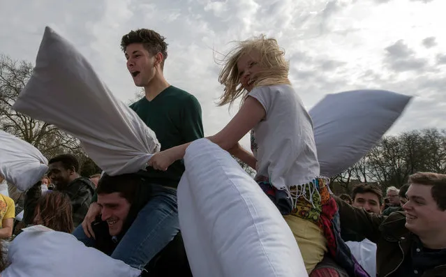 Members of the public take part in International Pillow Fight Day event on Kennington Park in London, Britain, 02 April 2016. The Pillow Fight Day attracts tens of thousands people in more than 100 cities all over the world each year. (Photo by Will Oliver/EPA)