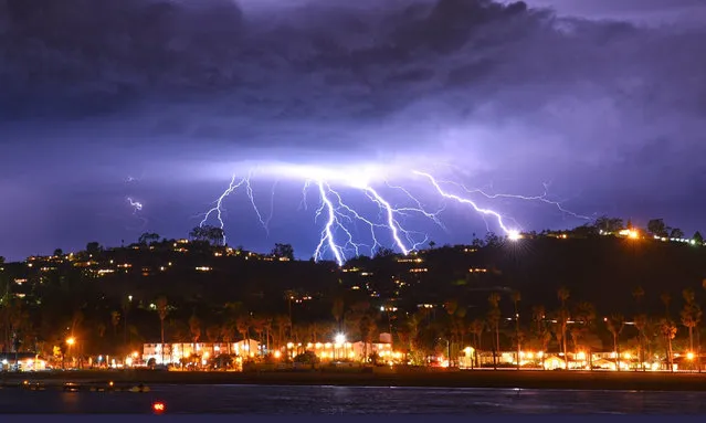 This time exposure photo provided by the Santa Barbara County Fire Department shows a series of lightning strikes over Santa Barbara, Calif., seen from Stearns Wharf in the city's harbor, Tuesday evening, March 5, 2019. A storm soaking California on Wednesday could trigger mudslides in wildfire burn areas where thousands of residents are under evacuation orders, authorities warned. The Santa Barbara County Sheriff's Office ordered 3,000 residents to evacuate hillside neighborhoods scarred by fires – including parts of Montecito hit by a disastrous debris flow just over a year ago. (Photo by Mike Eliason/Santa Barbara County Fire Department via AP Photo)