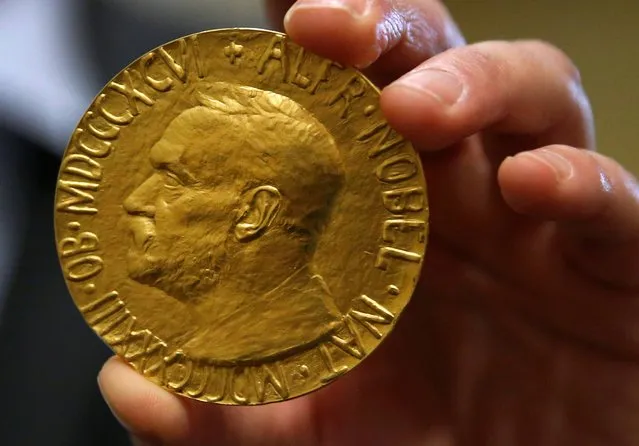 Bidder Ole Bjorn Fausa, of Norway, holds the 1936 Nobel Peace Prize in Baltimore, Thursday, March 27, 2014, the second Nobel Peace Prize ever to come to auction. The prize sold for a winning bid of $950,000 at auction, and an additional buyer's commission brought the final sale price to $1.16 million. The recipient was Argentina's foreign minister, Carlos Saavedra Lamas, who was honored for his role in negotiating the end of the Chaco War between Paraguay and Bolivia. (Photo by Patrick Semansky/AP Photo)