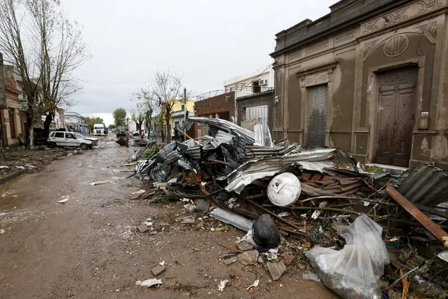 Debris is seen along a street in Dolores, the day after the city was hit by a tornado, April 16, 2016. (Photo by Andres Stapff/Reuters)