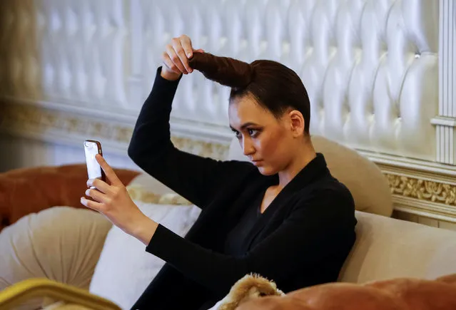 A model checks her hair backstage during Kazakhstan Fashion Week in Almaty, Kazakhstan, April 20, 2016. (Photo by Shamil Zhumatov/Reuters)