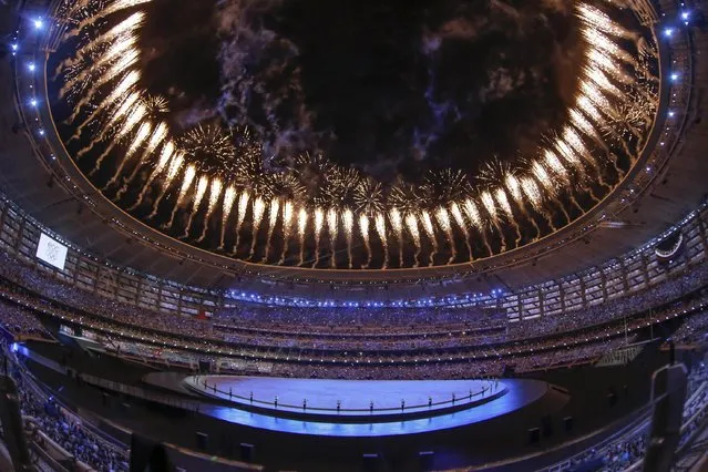 Fireworks explode over the stadium as actors perform during the opening ceremony of the 2015 European Games in Baku, Azerbaijan, Friday, June 12, 2015. (AP Photo/Dmitry Lovetsky)